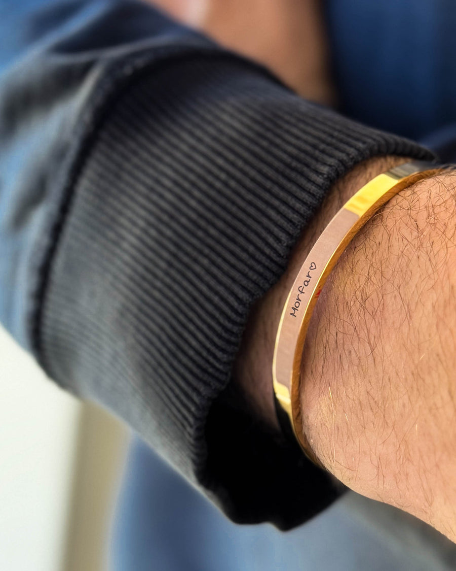 MARS SCRIPT Armband aus vergoldetem Edelstahl mit "Morfar" ♡ in Handschrift graviert, am Handgelenk, schwarzes Sweatshirt