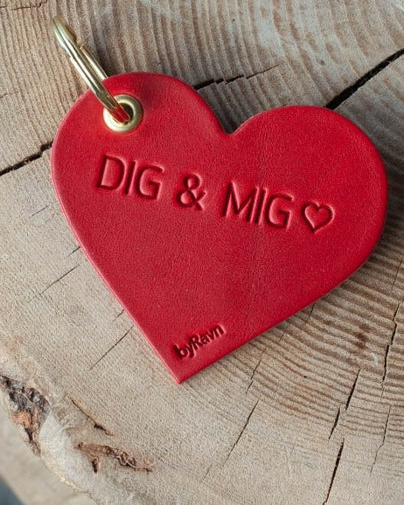 ROSE herzförmiger Schlüsselanhänger aus rotem Leder mit der Gravur "Dig & mig" ♡ und goldfarbenem Schlüsselring auf Baumstumpf
